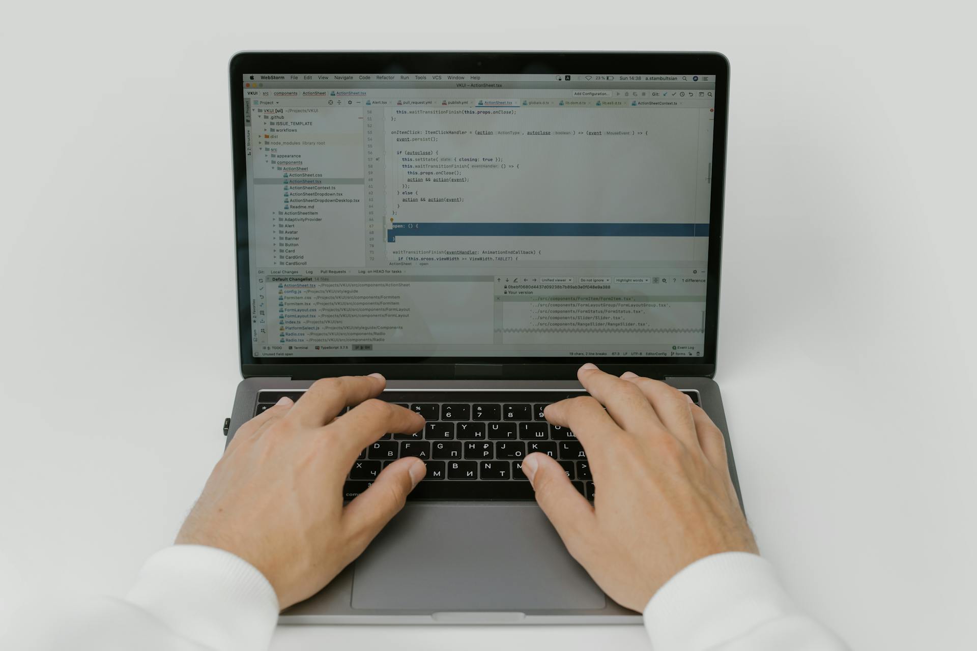 Close-up of hands coding on a laptop, showcasing software development in action